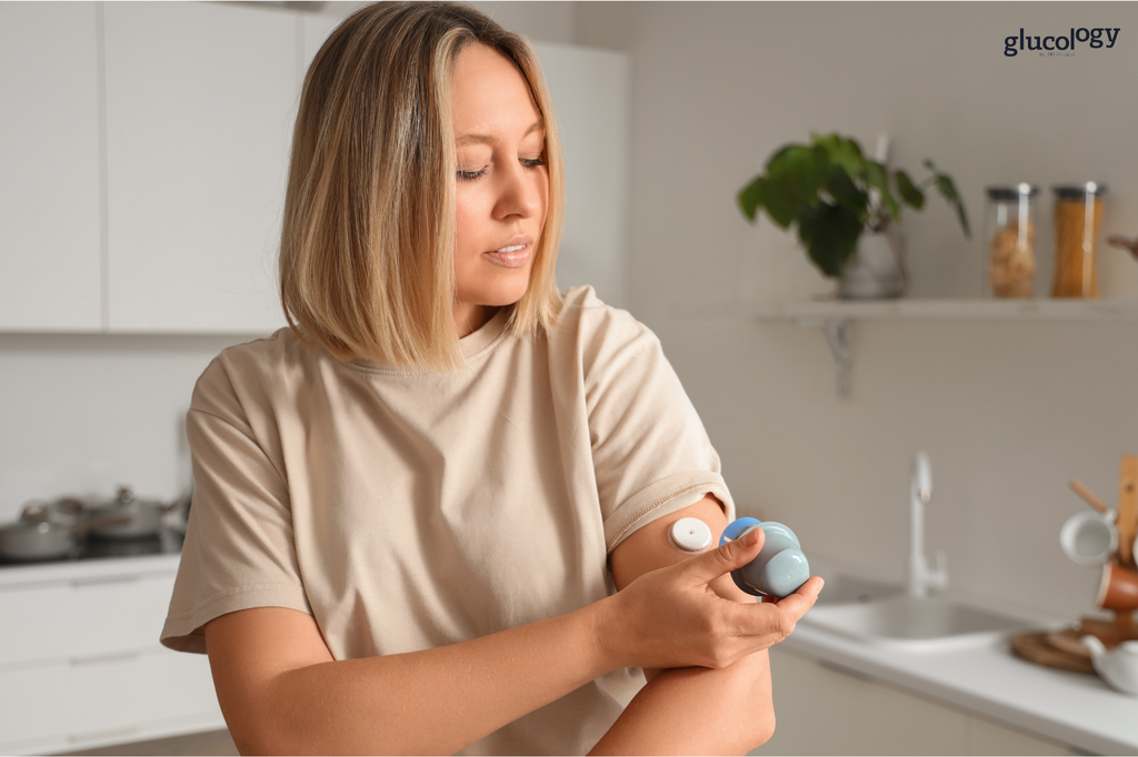 Woman applying a continuous glucose monitor (CGM) to the back of her upper arm.